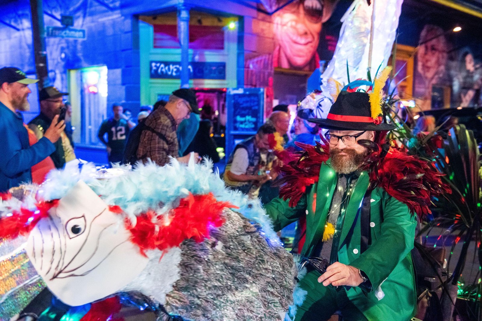 A costumed reveler riding a handmade creature