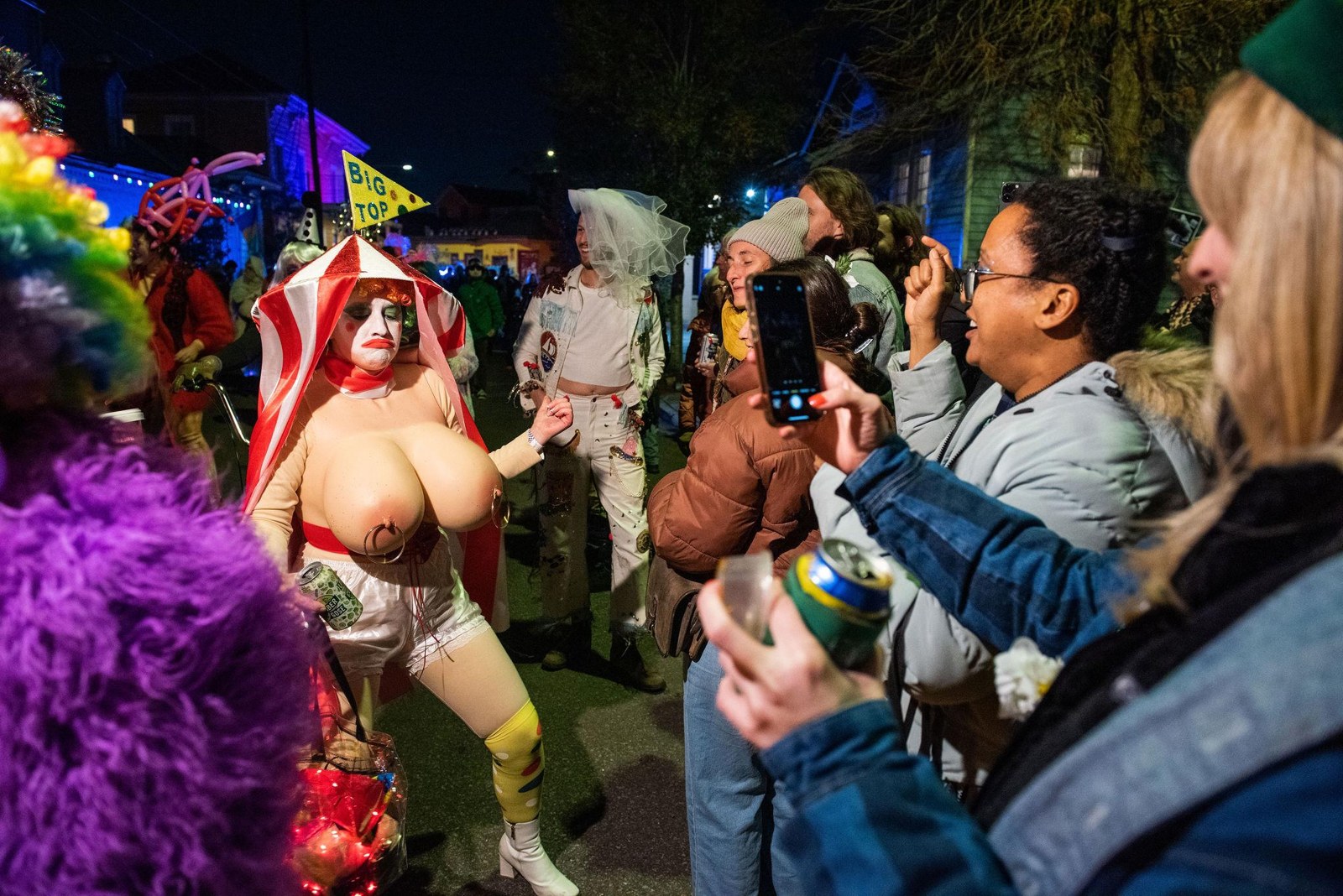 A costumed participant greeting spectators beside the parade
