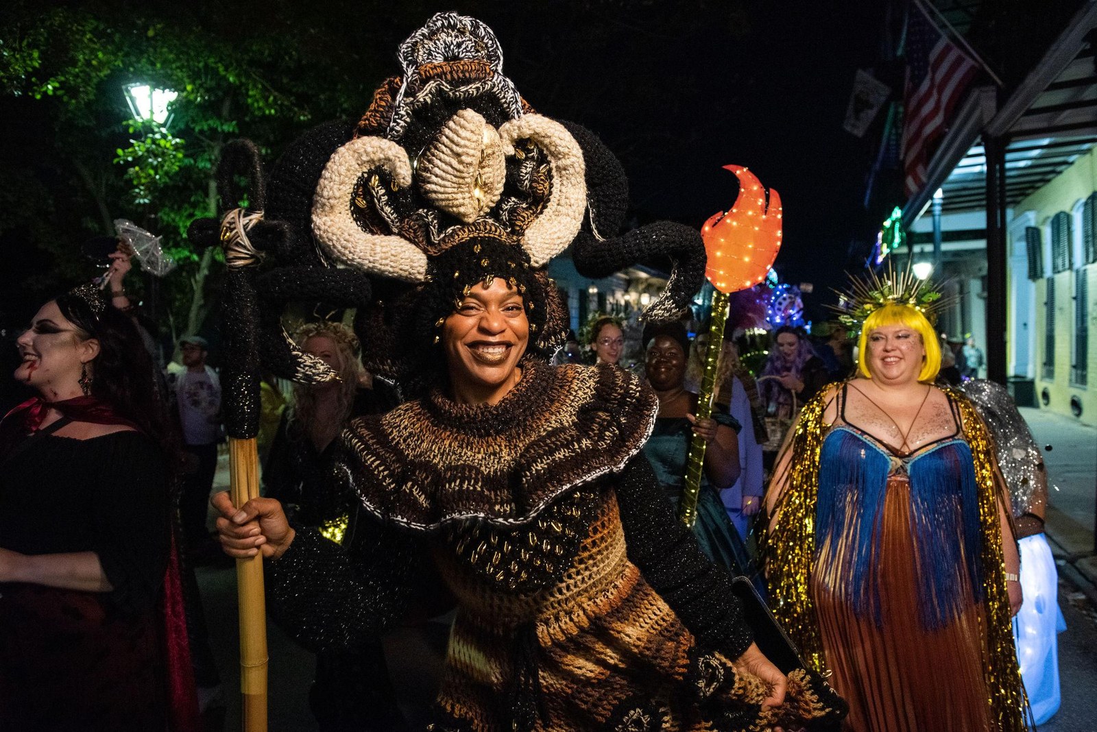 A smiling participant wearing an elaborate black and gold headdress